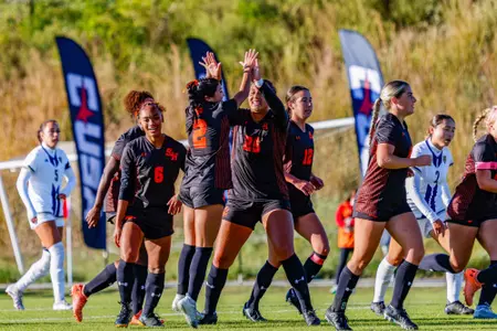 Pam Murray celebrates scoring against FIU with her teammates