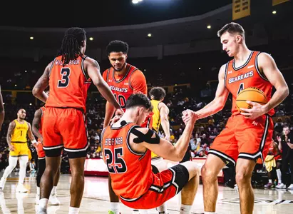 Anthony Wrzeszcz helps Cameron Huefner off the court at Arizona State