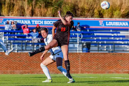 Katie Leal heads a ball against NM State