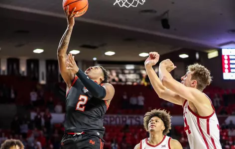 Qua Grant drives to the hoop against OU