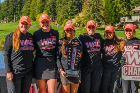 The Sam Houston women's golf team poses with the WAC Championship trophy.