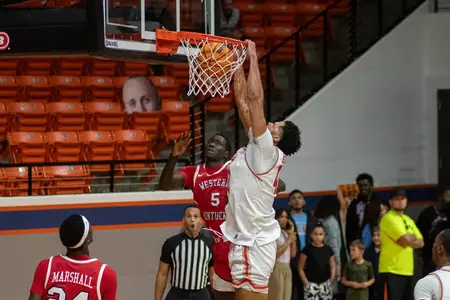 Kian Scroggins dunks against Western Kentucky
