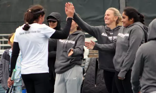 The tennis team celebrates a win over UT-Tyler