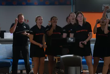 The bowling team watches a shot to open the 2024-25 season