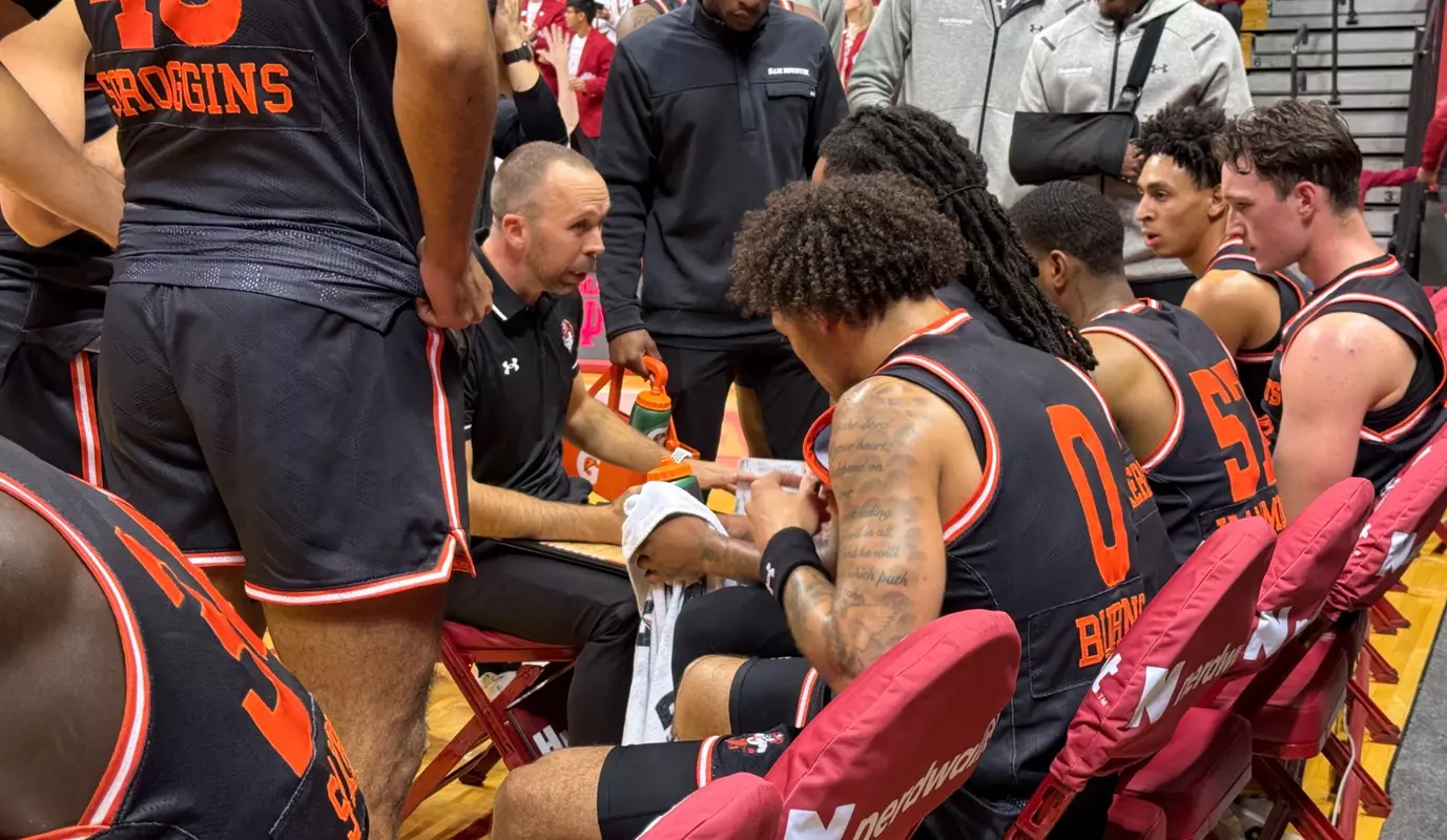 Coach Chris Mudge talks to the men's basketball team during a timeout at Indiana