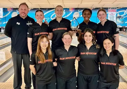 The bowling team celebrates winning the Lewis Flyer Classic