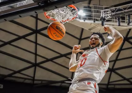Kian Scroggins finishes a dunk against FIU at Johnson Coliseum