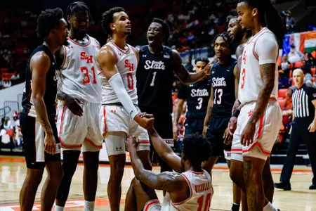 Owen McGlashan helps Damon Nicholas Jr. to his feet