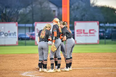 Members of the softball team meet in the circle