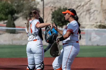 Elia Hebel and Hannah Scheaffer talk between innings