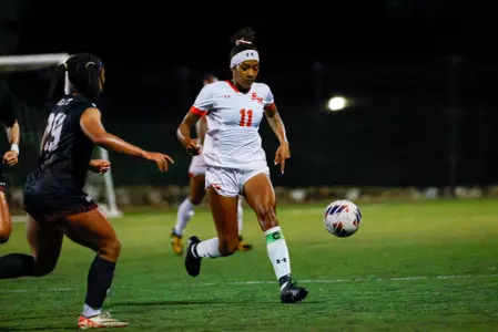 Andrea Nugent dribbles against NM State