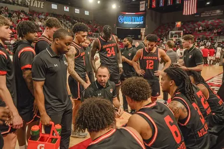 The team huddles during a timeout at Jacksonville State