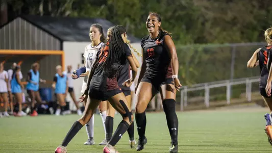 Gabrielle Gipson and Indigo Sims celebrate a goal against UTEP