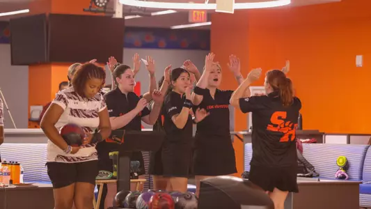 The bowling team celebrates a shot at the Kat Klub