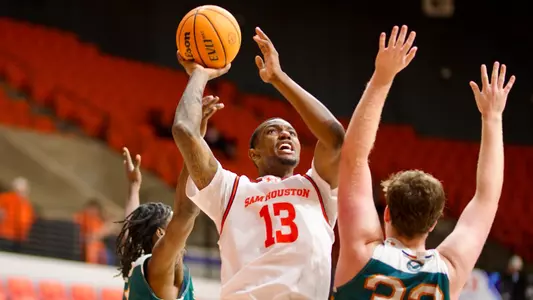 Isaiah Manning goes up for a shot against the College of Biblical Studies