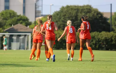 Members of the soccer team jog down field