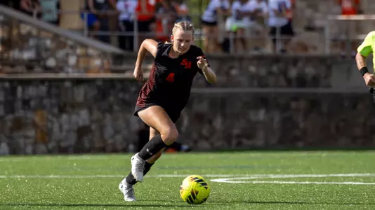 Sara Benton dribbles up the field