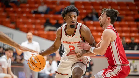 Jacobe Coleman dribbles against a WKU defender