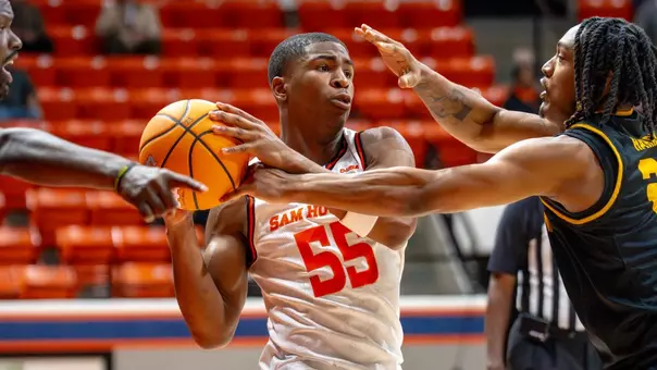 Jacob Walker fends off defenders against Kennesaw State