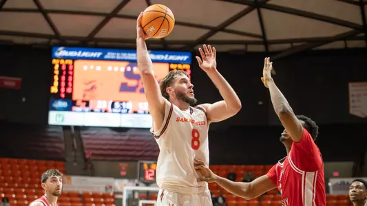 Veljko Ilic shots over a Western Kentucky defender