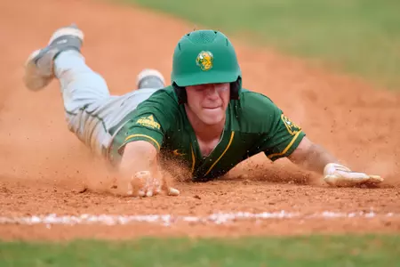 North Dakota State Bison Cadyn Schwabe (19) slides into third base during an NCAA baseball game against the Maine Black Bears on March 11, 2022 at Chain of Lakes Stadium in Winter Haven, Florida. (Mike Janes/Four Seam Images)