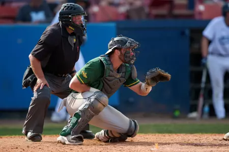 Umpire Greg Kiewitt and North Dakota State Bison catcher Will Busch (7) during an NCAA baseball game against the Maine Black Bears on March 11, 2022 at Chain of Lakes Stadium in Winter Haven, Florida. (Mike Janes/Four Seam Images)
