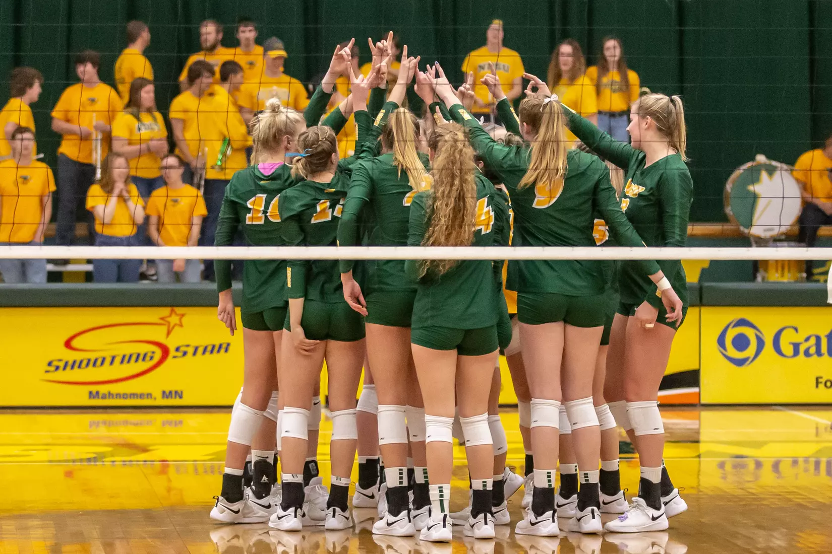 North Dakota State volleyball with horns up prior to match against Omaha in the Bentson Bunker Fieldhouse.