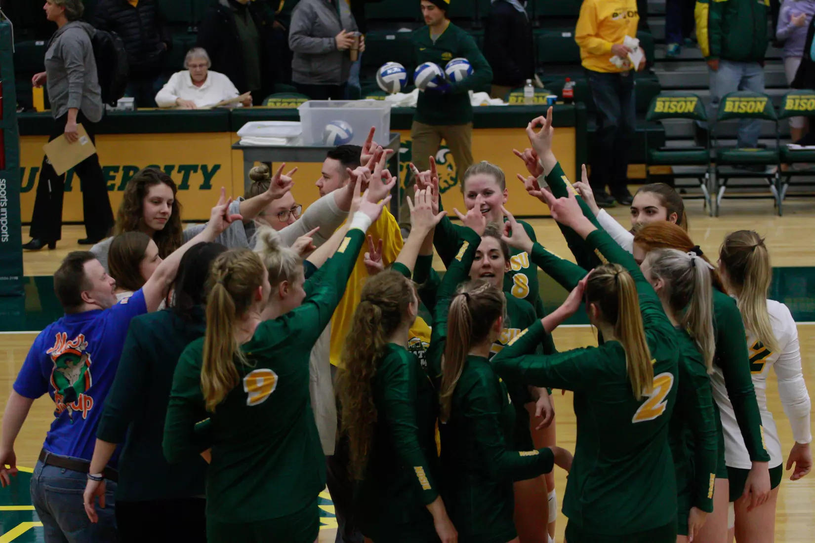 North Dakota State volleyball with horns up following 3-1 win over Oral Roberts on Nov. 17 in Bentson Bunker Fieldhouse.