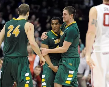 Marshall Bjorklund hugs Lawrence Alexander.