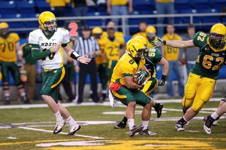 Nate Tanguay (62) disrupts a run by Darius Anderson (8)