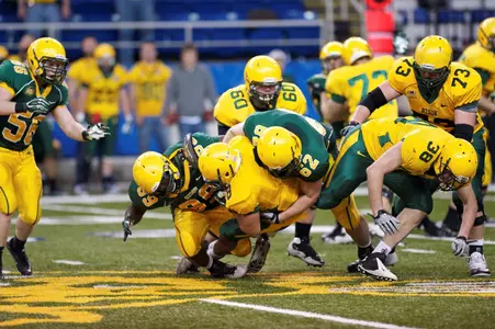 Nate Tanguay (62) tackles Darius Anderson (8)