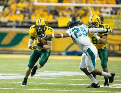Trevor Gebhart (3) gets a block from Carey Woods (83).