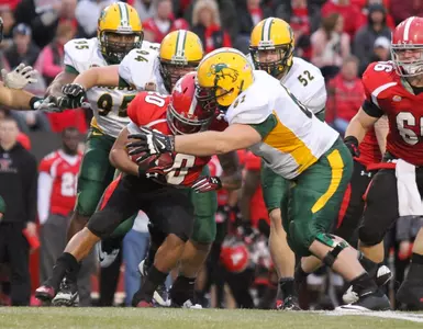Brian Schaetz (61) and teammates make the tackle.