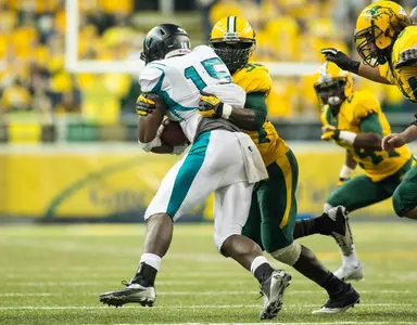 Carlton Littlejohn tackles as Danny Luecke (94) pursues.