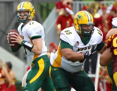 Adam Schueller (65) protects Carson Wentz (11)