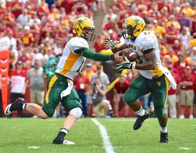 Carson Wentz (11) hands off to John Crockett (23)