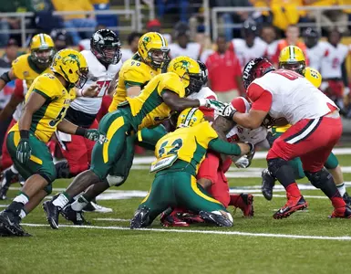 Travis Beck (52) and Carlton Littlejohn (38) lead defense