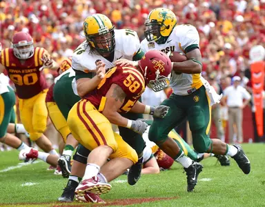 Jesse Hinz (76) blocks for John Crockett (23)