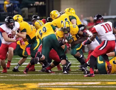 Joe Haeg (59) blocks for John Crockett (23)