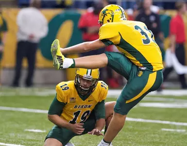 Tom Barneson (31) kicks, Ben LeCompte (19) holds