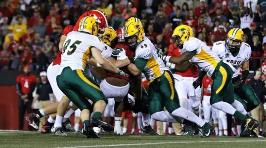 Nick DeLuca (49) leads a group of Bison tacklers