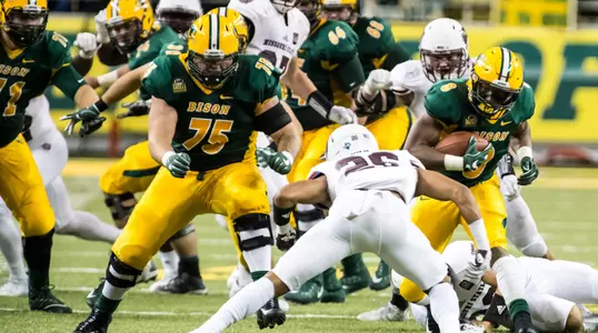 Austin Kuhnert (75) gets downfield to block for Bruce Anderson (8).