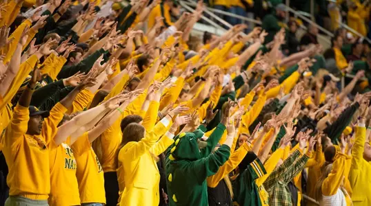 NDSU football fans with their arms up