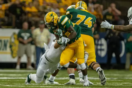 Ty Brooks runs the football past Tanner Volson's block
