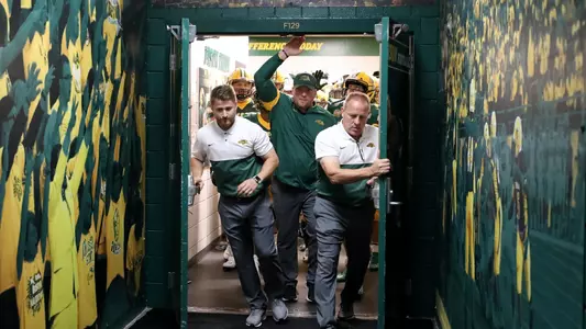 Matt Entz leads NDSU out of the locker room