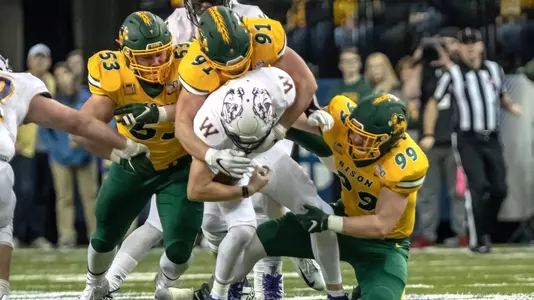 Cole Karcz, Derrek Tuszka and Spencer Waege tackle a Western Illinois player