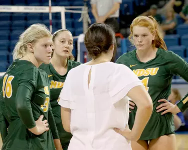 Kalli Hegerle, McKenzie Burke and Kirstin Tidd listen to head coach Jennifer Lopez during timeout vs. Niagara during Blue & White Classic.