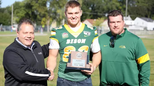 Ben Ellefson with Allstate AFCA Good Works Team trophy
