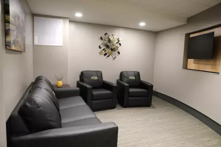 Lounge with chairs and a television