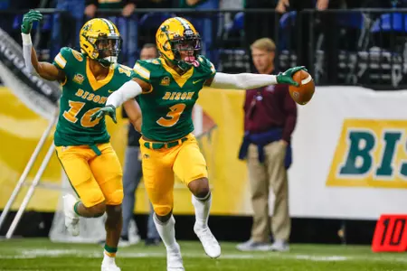 Jasir Cox and Dom Jones celebrate an interception